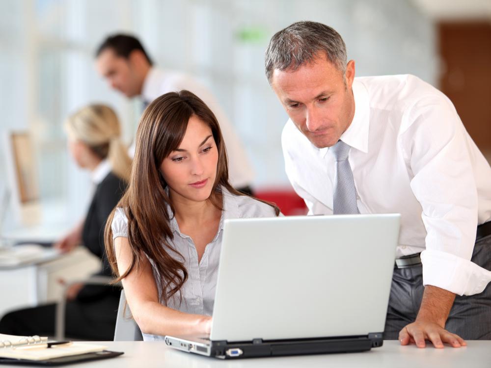 A procurement specialist working with a colleague.