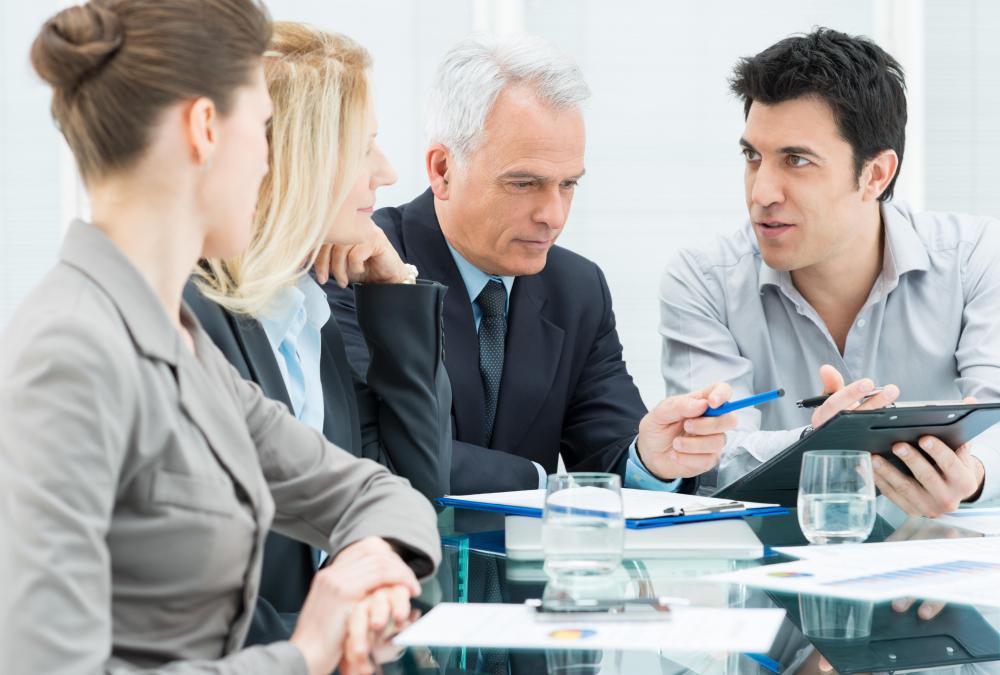 Company management and auditors discuss the findings of an audit during the reporting phase.