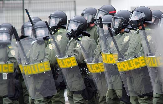 Riot-control uniforms have visible, bulky armor that is meant to intimidate.