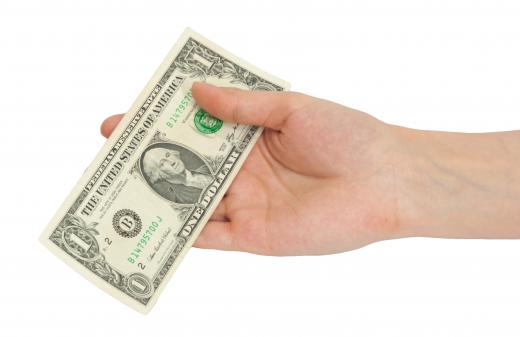 A person tipping a waiter at the front of the house.