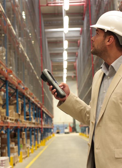 Man checking inventory with a portable device.